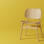 a wooden chair on a yellow background
